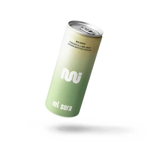 A single can of mi sora Balance ginger matcha cooler floating above a white liquid splash on a solid black background.